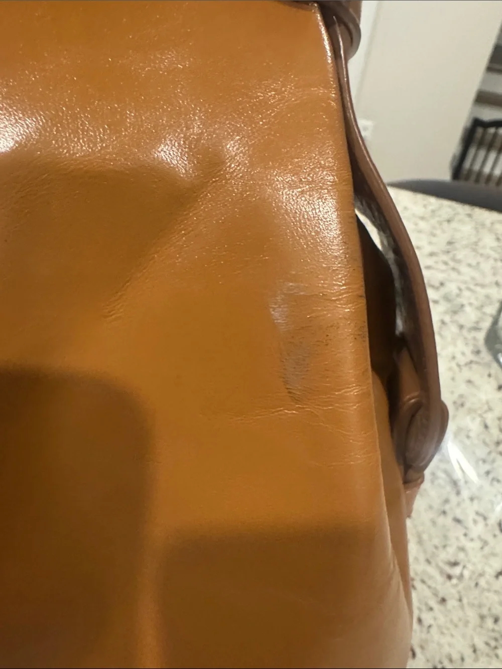 The Find Classic Tan Leather Weekender Travel Bag with Gold Hardware Buckle.